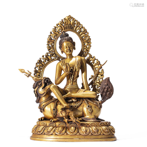 A TIBETAN BRONZE-GILT DEITY