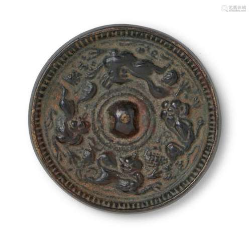 A SMALL CHINESE BRONZE 'ANIMAL AND GRAPE' MIRROR TAN...