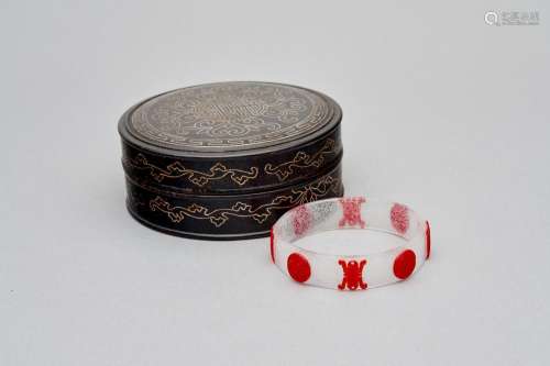 A translucent glass bangle with red overlay