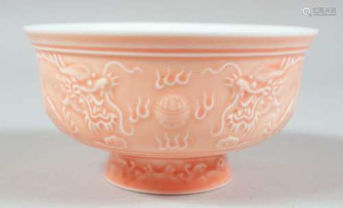 A CHINESE PINK GLAZED PORCELAIN BOWL, the exterior with rais...