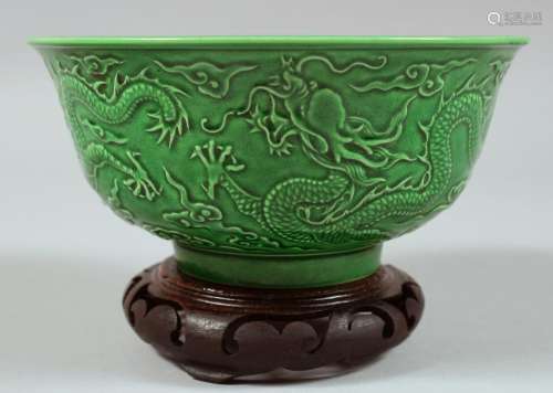 A CHINESE GREEN GLAZED PORCELAIN DRAGON BOWL with hardwood s...