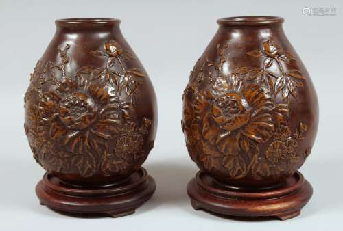 A PAIR OF JAPANESE HEAVY BRONZE VASES with hardwood stands, ...