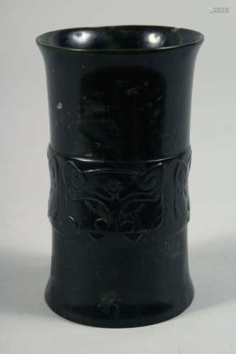 A CHINESE JADE HOLLOW CYLINDER, with a band of carved decora...