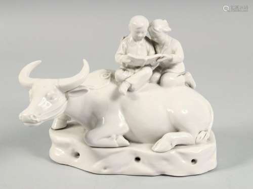 A CHINESE PORCELAIN FIGURE OF AN OXEN with two seated figure...