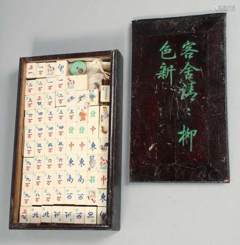 A CHINESE BOXED MAH JONG SET with bone and wood counters, bo...