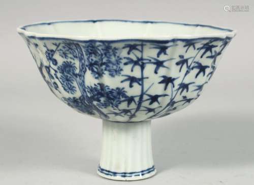 A CHINESE BLUE AND WHITE PORCELAIN STEM CUP, painted with pl...