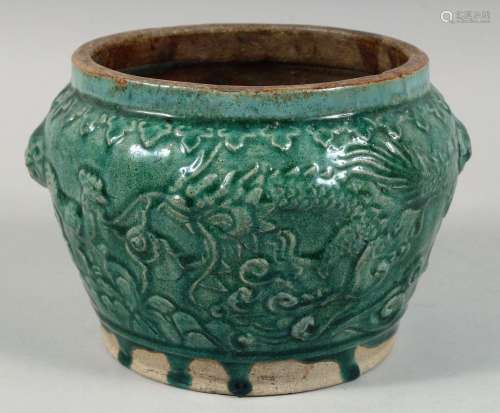 A CHINESE GREEN GLAZED POTTERY PLANTER, with raised decorati...