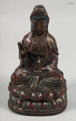 A BRONZE FIGURE OF A SEATED BUDDHA, holding a small vile in ...
