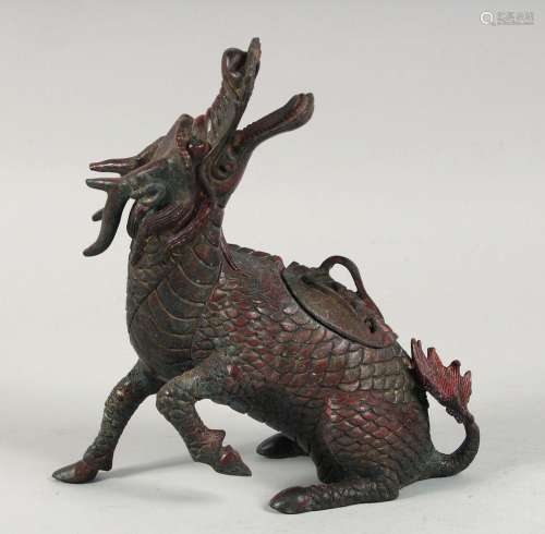 A CHINESE BRONZE DRAGON FORM CENSER, with traces of red pain...