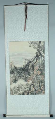 A CHINESE HANGING SCROLL PAINTING, depicting a rocky, wooded...