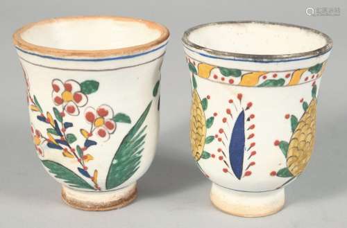 A PAIR OF TURKISH KUTAHYA POTTERY WATER CUPS, each painted w...