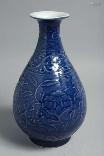 A CHINESE BLUE GLAZE PORCELAIN VASE, the body with carved fl...