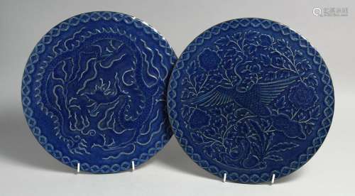 A PAIR OF CHINESE BLUE GLAZED CIRCULAR PLAQUES, one carved w...