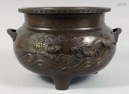 A LARGE JAPANESE BRONZE TWIN HANDLE TRIPOD CENSER, with reli...
