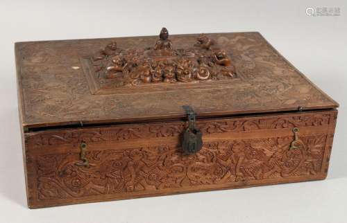 A LARGE INDIAN CARVED WOOD LIDDED BOX carved all over with v...