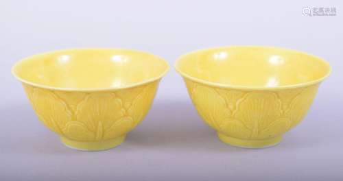 A PAIR OF CHINESE YELLOW GLAZED PORCELAIN CUPS, each with si...
