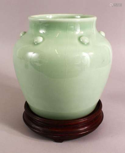 A CHINESE CELADON GLAZED VASE AND STAND, with a row of bosse...