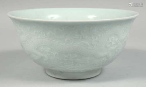 A CHINESE PALE CELADON PORCELAIN BOWL, the exterior with rai...
