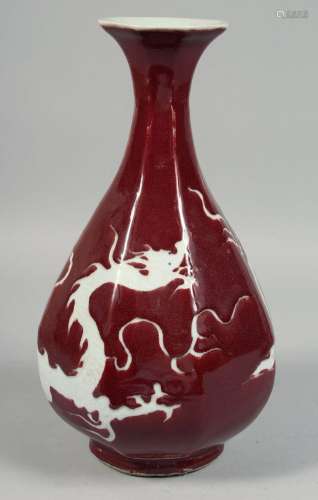 A CHINESE RED GROUND OCTAGONAL PORCELAIN VASE, decorated wit...