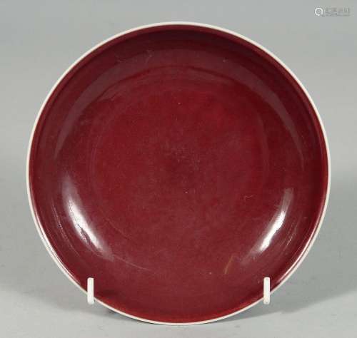 A CHINESE RED GLAZE PORCELAIN DISH, the base with incised si...