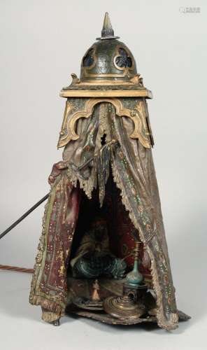 A BERGMAN COLD PAINTED BRONZE TENT FORM LAMP, with seated fi...