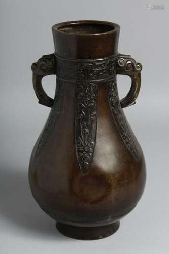 A CHINESE TWIN-HANDLED BRONZE VASE in the archaic style, wit...