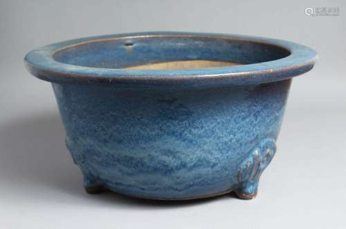 A LARGE CHINESE BLUE-GLAZED PLANTER, slightly raised on thre...