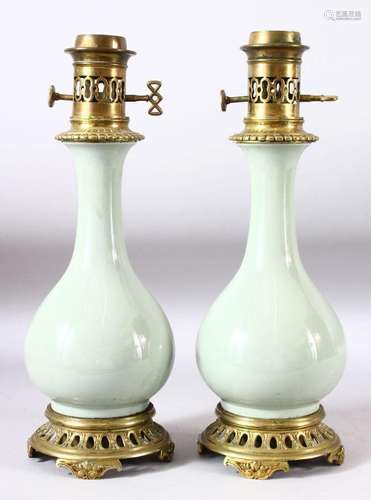 A PAIR OF CELADON PORCELAIN VASES CONVERTED TO LAMPS with br...