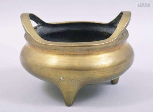 A GOOD CHINESE BRASS TWIN HANDLE TRIPOD CENSER, the base wit...