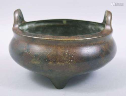 A CHINESE BRONZE TWIN HANDLE TRIPOD CENSER, with four charac...