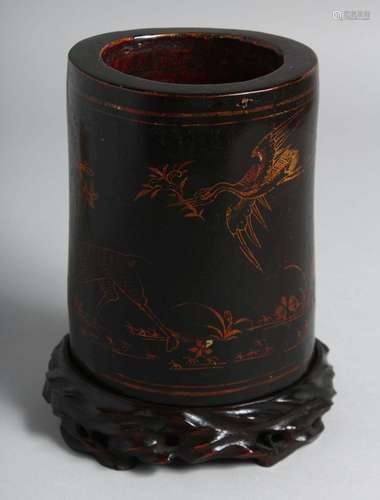 A CHINESE LACQUERED BAMBOO BRUSH POT on a fitted hardwood st...