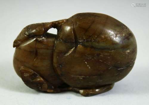 A CHINESE CARVED HARDSTONE FRUIT, 7cm long.