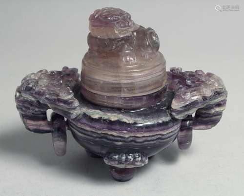 A CHINESE CARVED AMETHYST TRIPOD CENSER AND COVER, with twin...