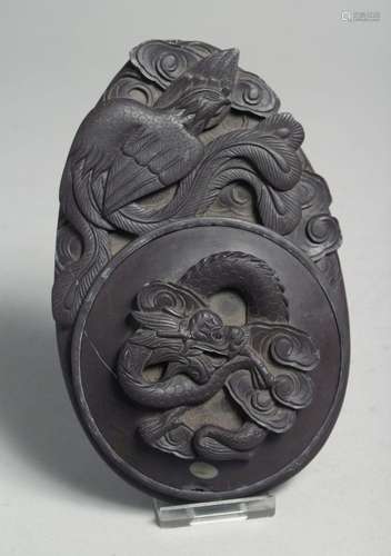 A CHINESE CARVED INKSTONE, with dragon and phoenix, 16cm lon...