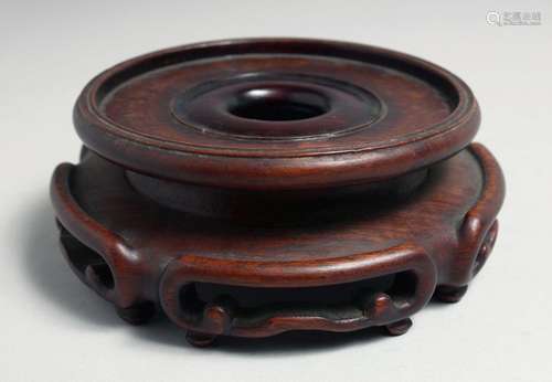 A CHINESE CARVED HARDWOOD CIRCULAR VASE STAND, to fit a base...