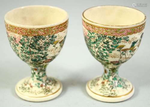 A PAIR OF JAPANESE SATSUMA EGG CUPS, with foliate decoration...