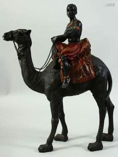 A MODEL OF A NUBIAN FIGURE RIDING A CAMEL, 38cm high.