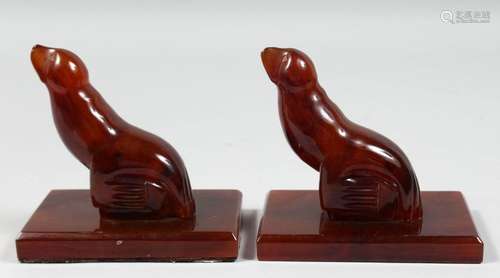 A RARE PAIR OF ART DECO BAKELITE SEAL SHAPED BOOK STANDS, ba...