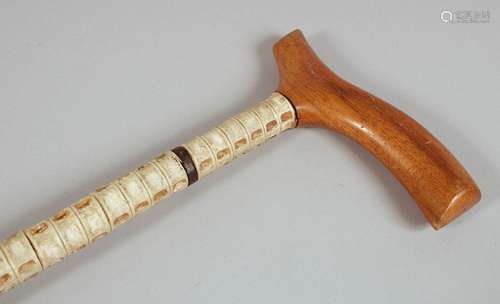 AN ANTIQUE SHARK VERTEBRAE WALKING STICK, with wooden handle...