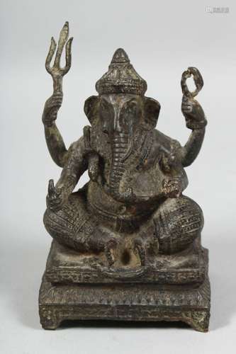 AN INDIAN BRONZE FIGURE OF GANESH, seated on a rectangular b...