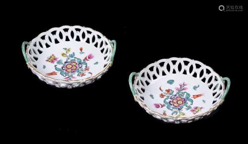 A PAIR OF WORCESTER POLYCHROME PIERCED TWO HANDLED ROUND BAS...