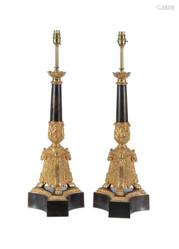 A PAIR OF GILT AND PATINATED METAL TABLE LAMPS IN EMPIRE STY...