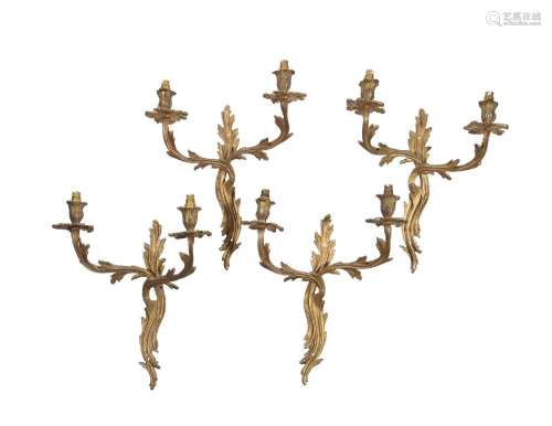 A SET OF FOUR GILT METAL TWIN ARM WALL APPLIQUES IN LOUIS XV...