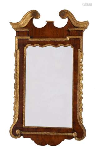 A GEORGE II WALNUT AND PARCEL GILT WALL MIRROR