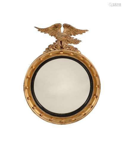 A GILTWOOD AND CONVEX MIRROR IN REGENCY STYLE