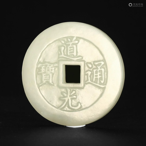 A WHITE JADE 'COIN' PENDANT