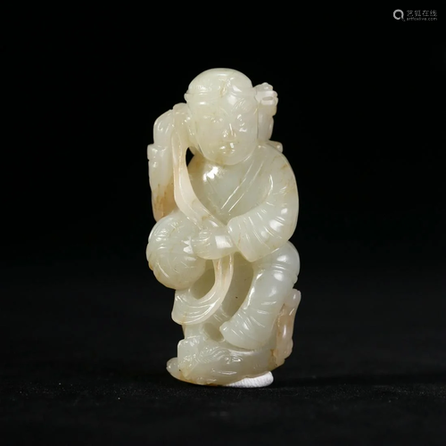 A CHINESE CARVED JADE FIGURE