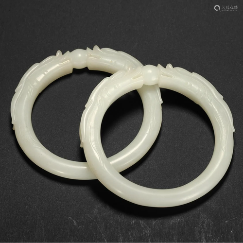 A PAIR OF WHITE JADE 'DRAGON' BRACELETS