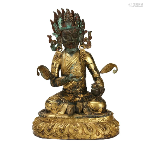 A GILT-BRONZE FIGURE OF SEATED GUARDIAN