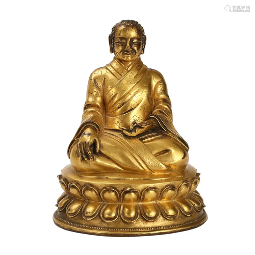 A GILT-BRONZE FIGURE OF SEATED LAMA